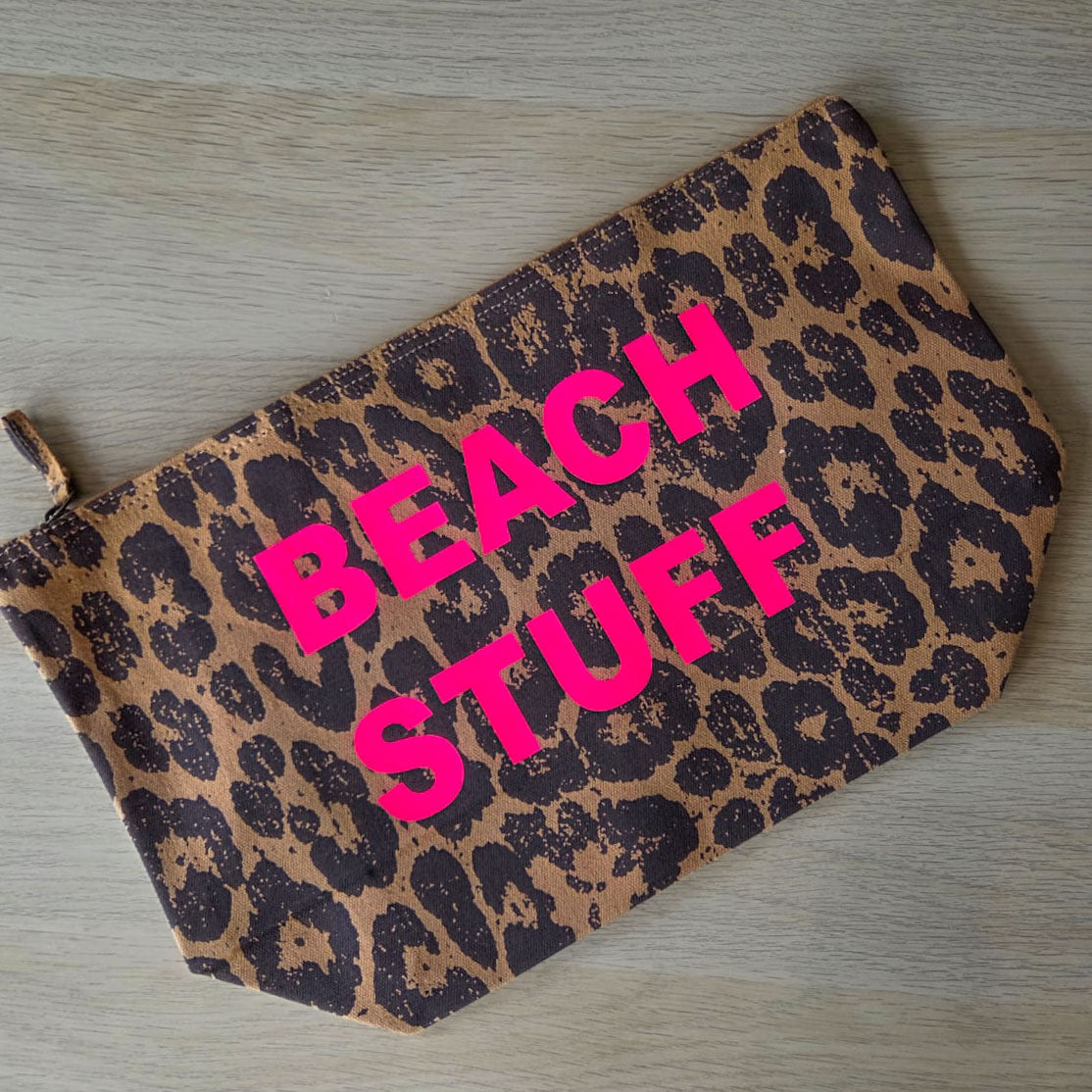 Close-up of leopard print recycled canvas pouch fabric and zip pull